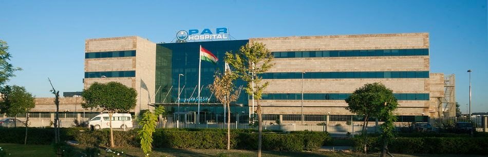 PAR Hospital in Erbil — the hospital building with its glass entrance tower and rooftop sign.